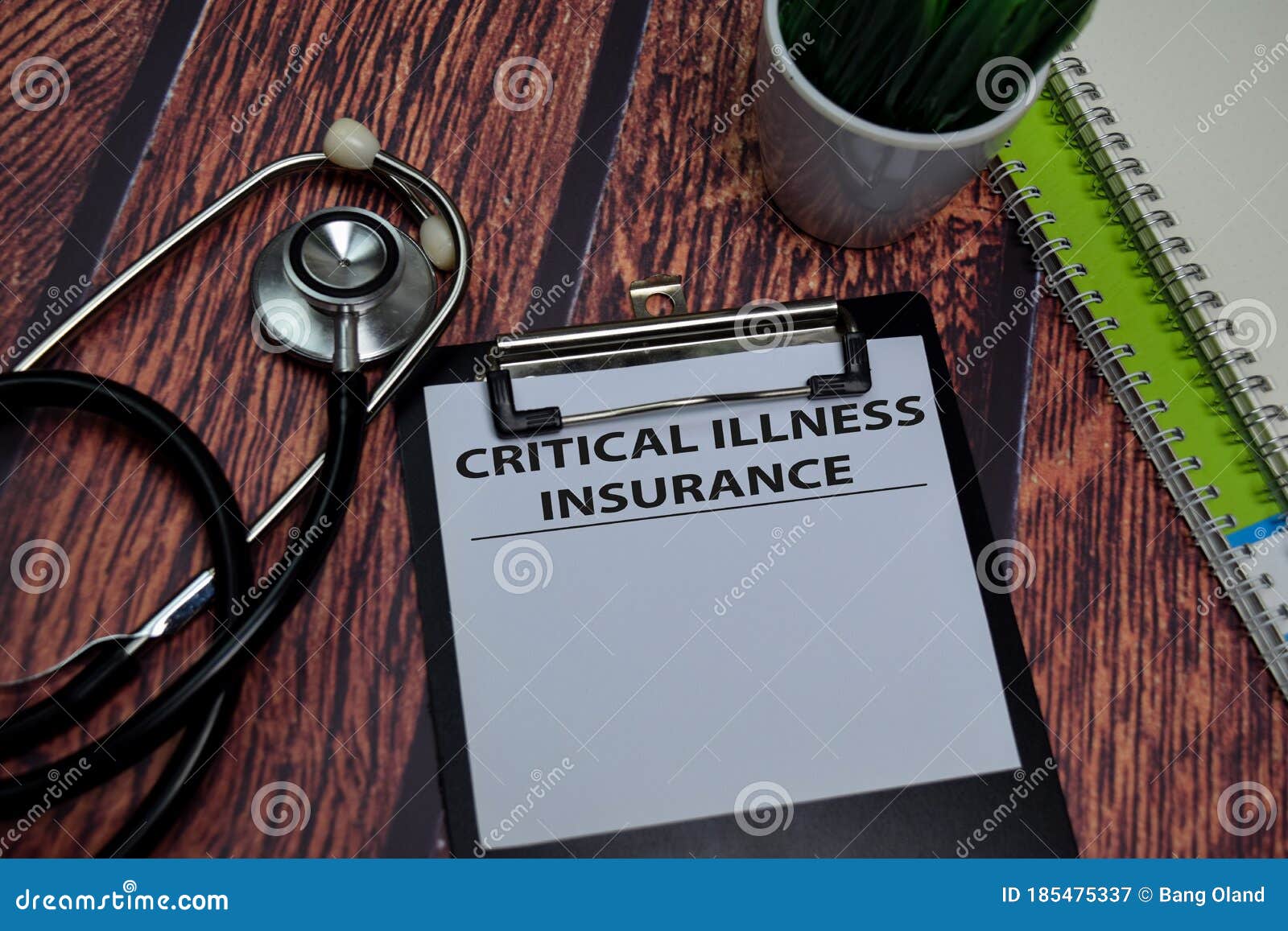 critical illness insurance write on paperwork  on wooden table