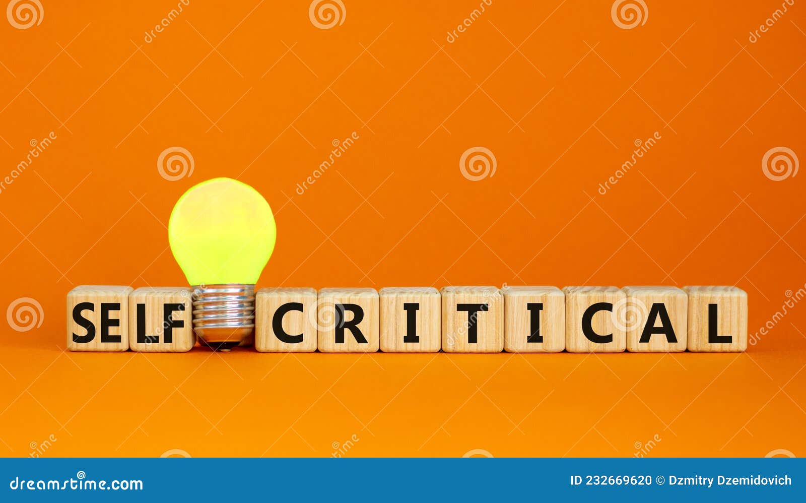 critical or self-critical . cubes with words `self-critical or critical`. yellow light bulb. beautiful orange background.