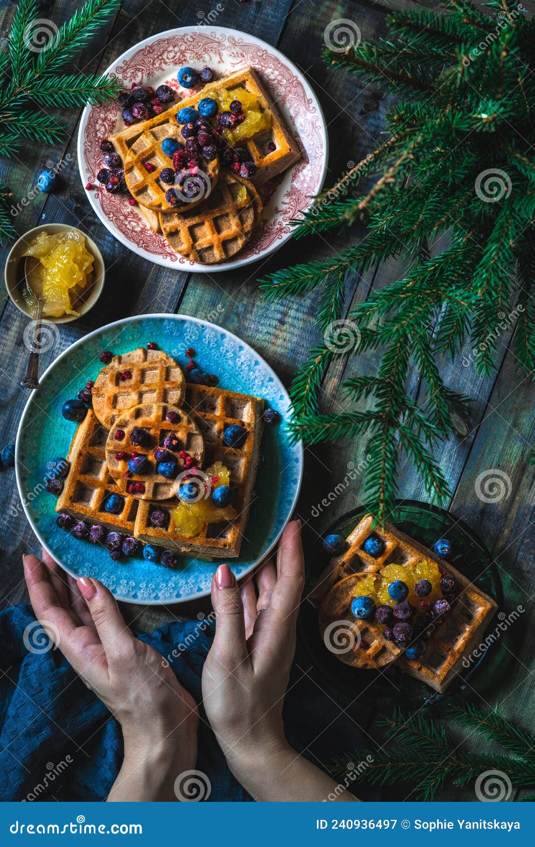 croissant waffle or croffle with srawberry and blueberry sauce served in plate and dark background. close up, copy space