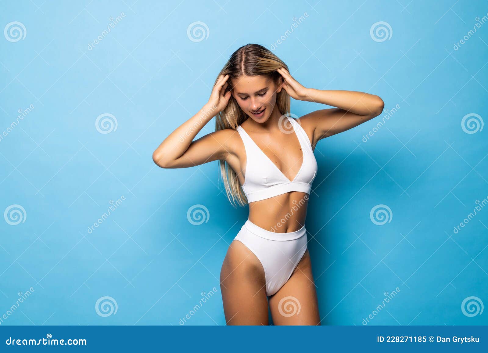 Front view of a fit and young girl dressed in blue underwear