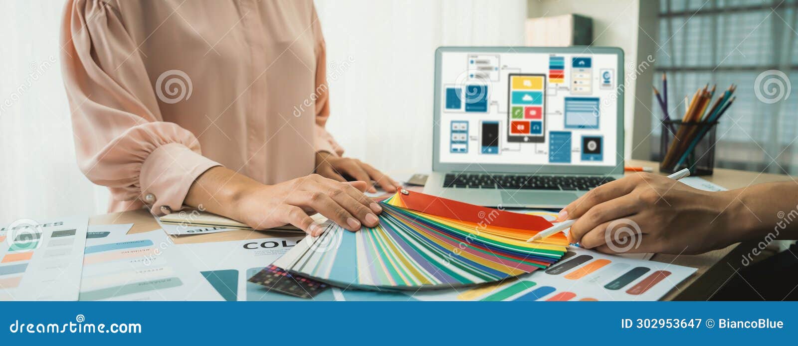 er chooses color while laptop displayed ui and ux s variegated.