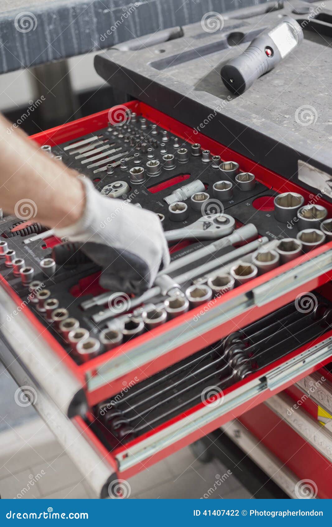 Cropped Image of Male Mechanic Taking Tool from Drawer in Car