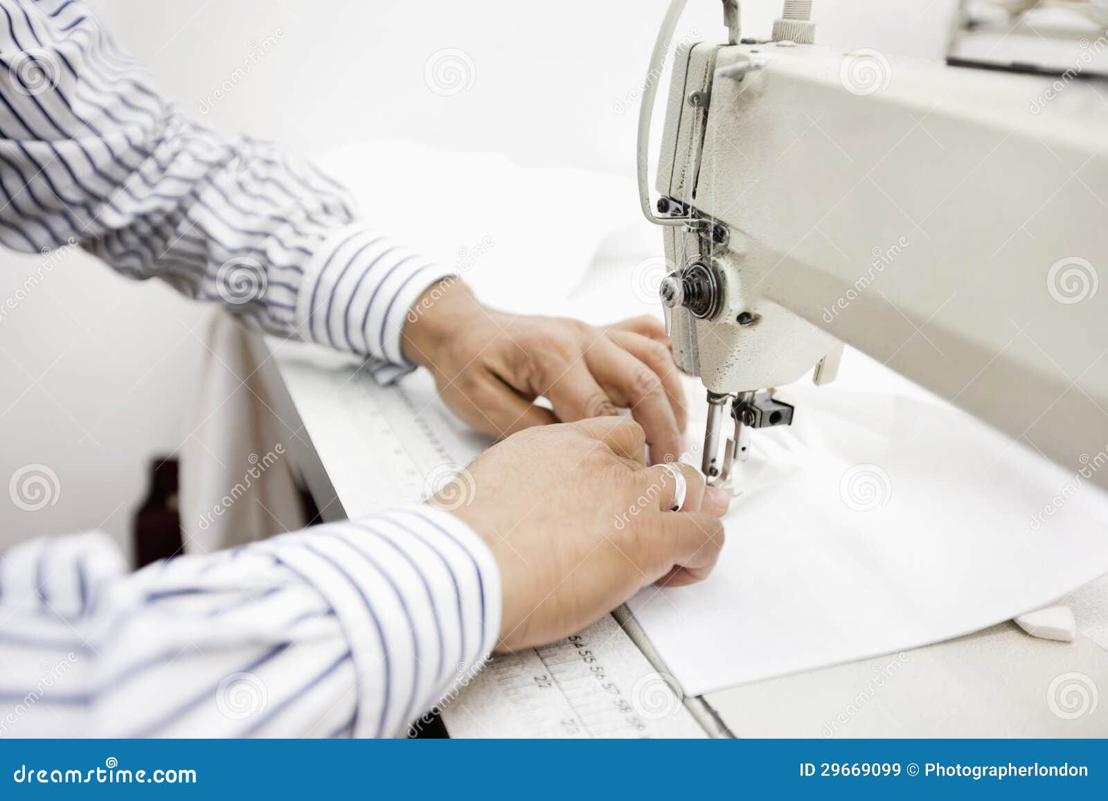 Cropped Image of Tailor Sewing Cloth on Sewing Machine Stock Image