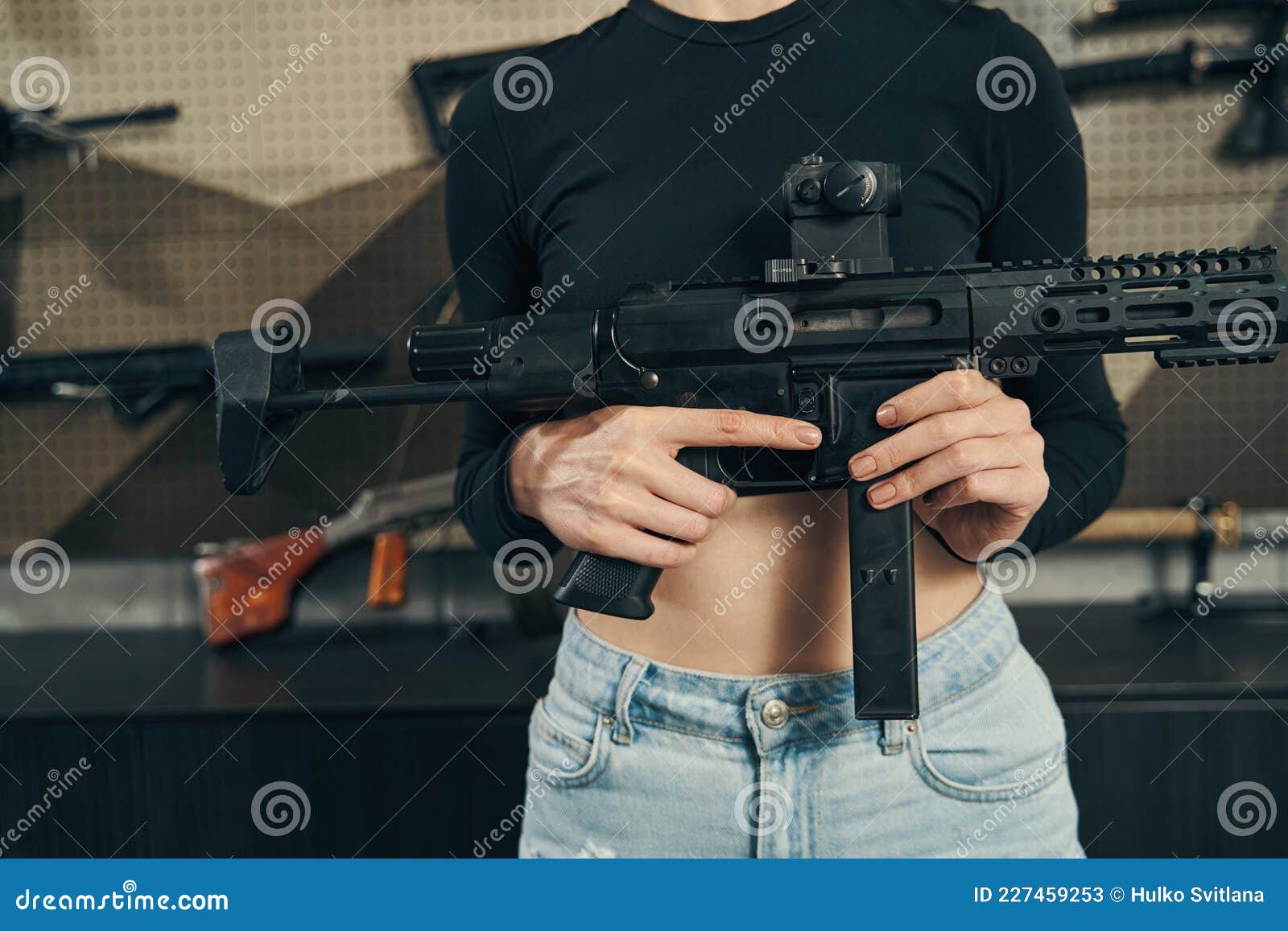 experienced saleslady showing a new weapon at the arms store