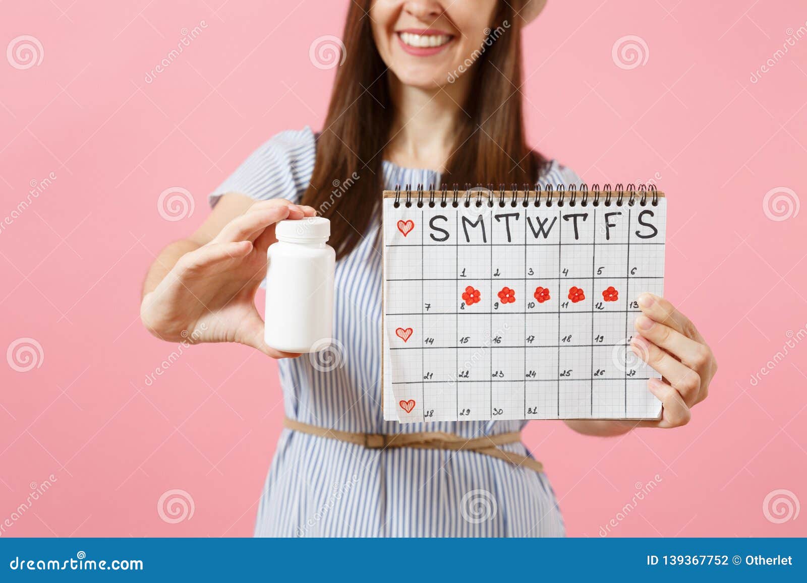 Cropped Photo Of Woman In Blue Dress Holding White Bottle With Pills