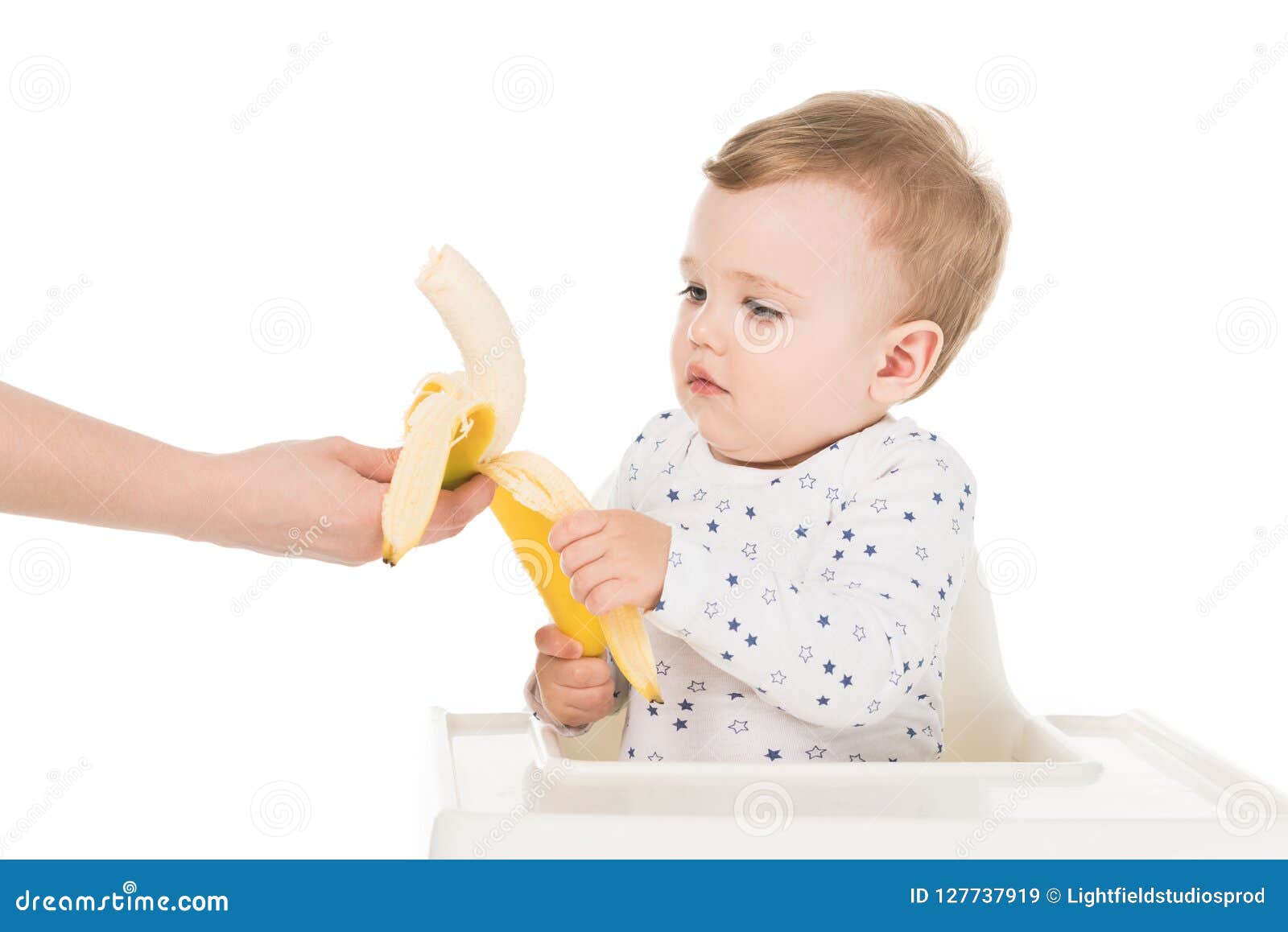 Cropped Shot of Mother Giving Banana To Son in Highchair Stock Image ...
