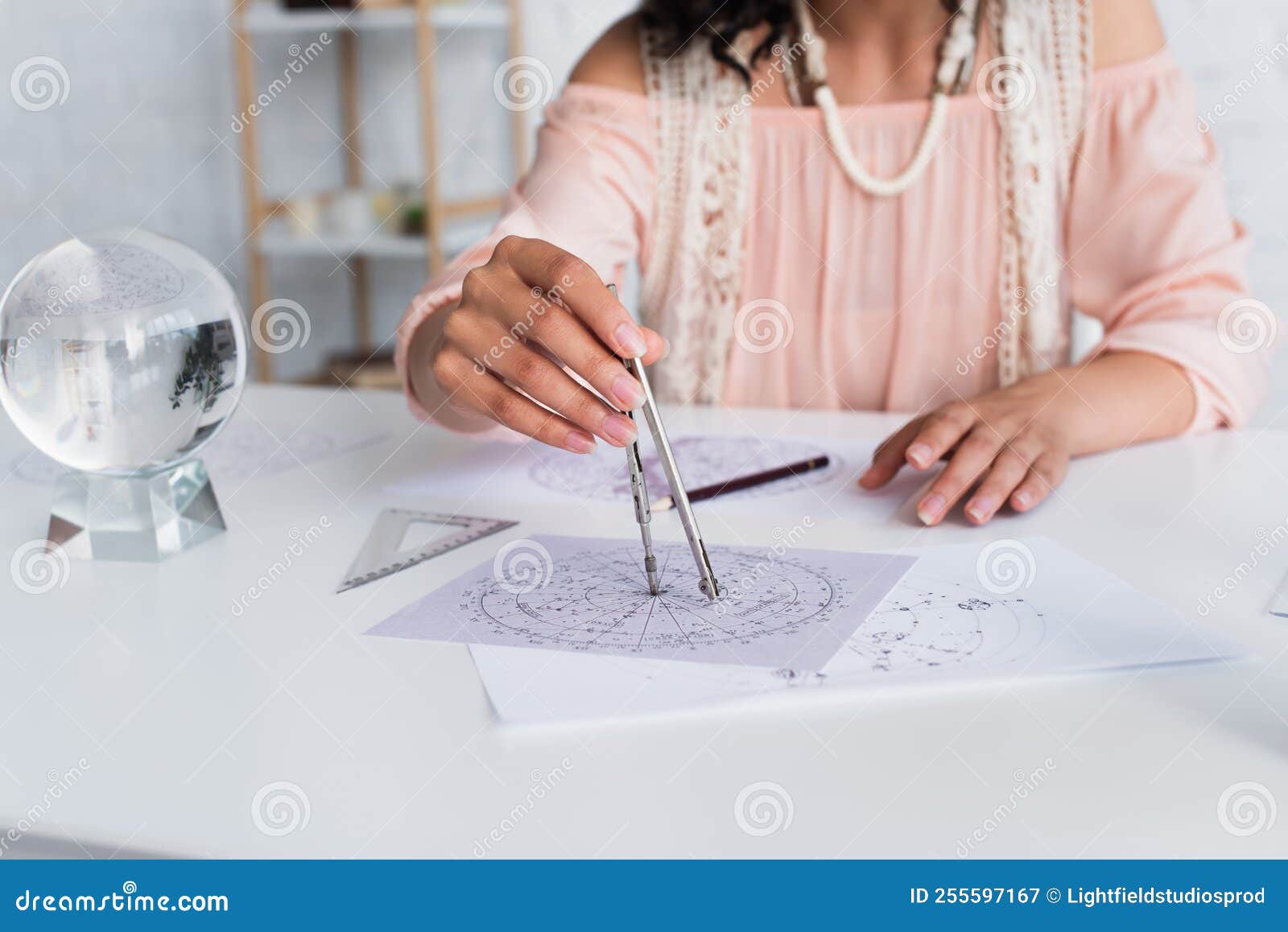 cropped view of blurred astrologist drawing
