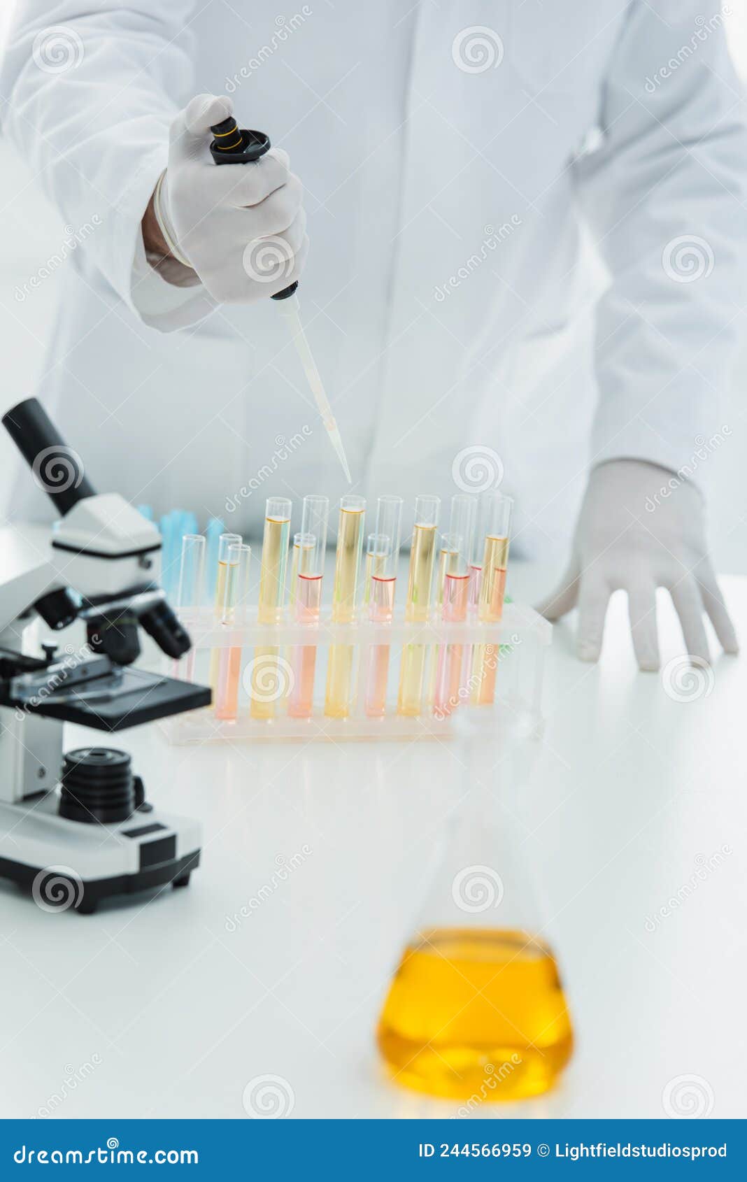 cropped view of geneticist using micropipette