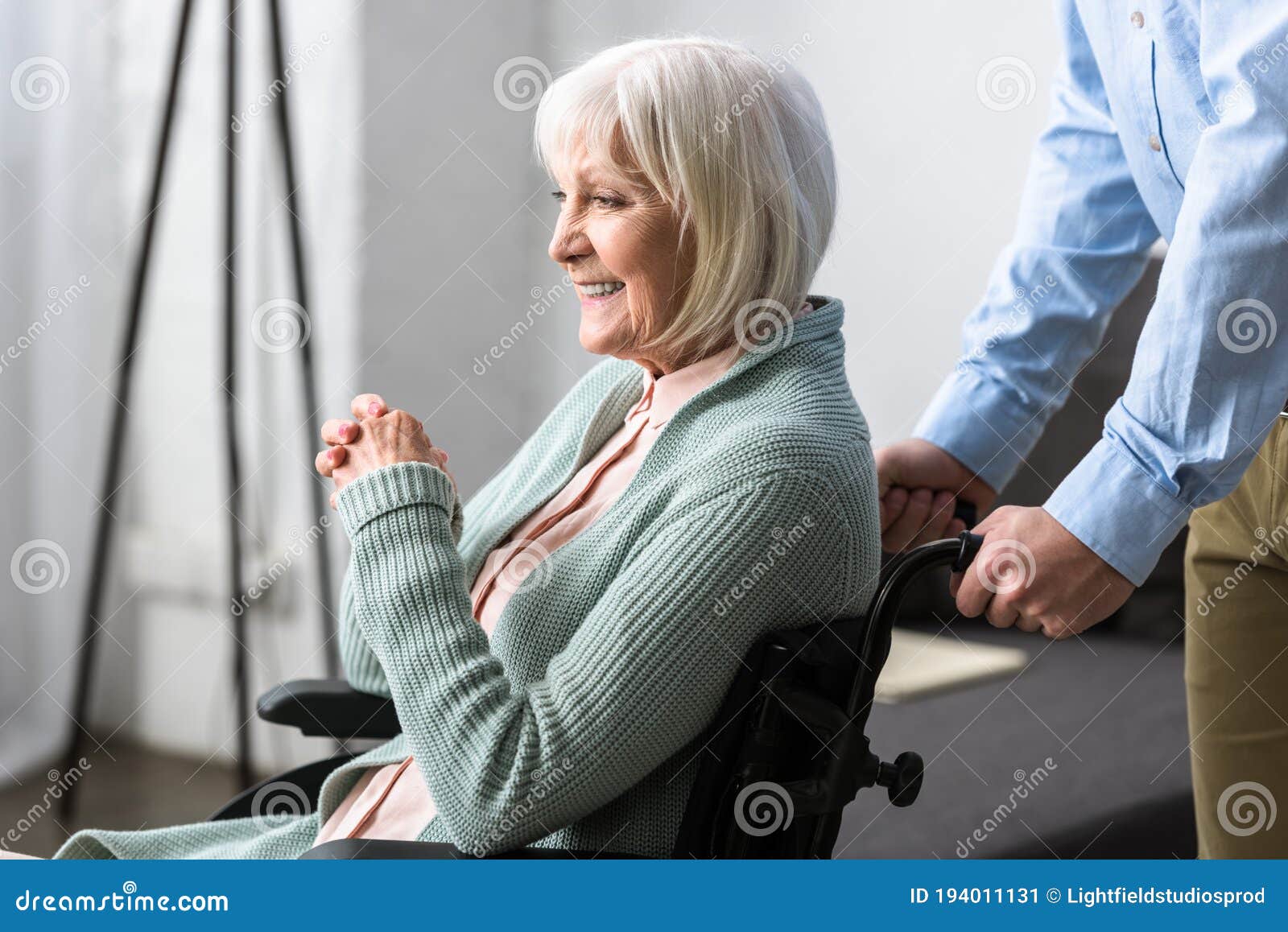 View Of Man Carrying Disabled Senior Mother On Wheelchair Stock Image Image Of Cheerful