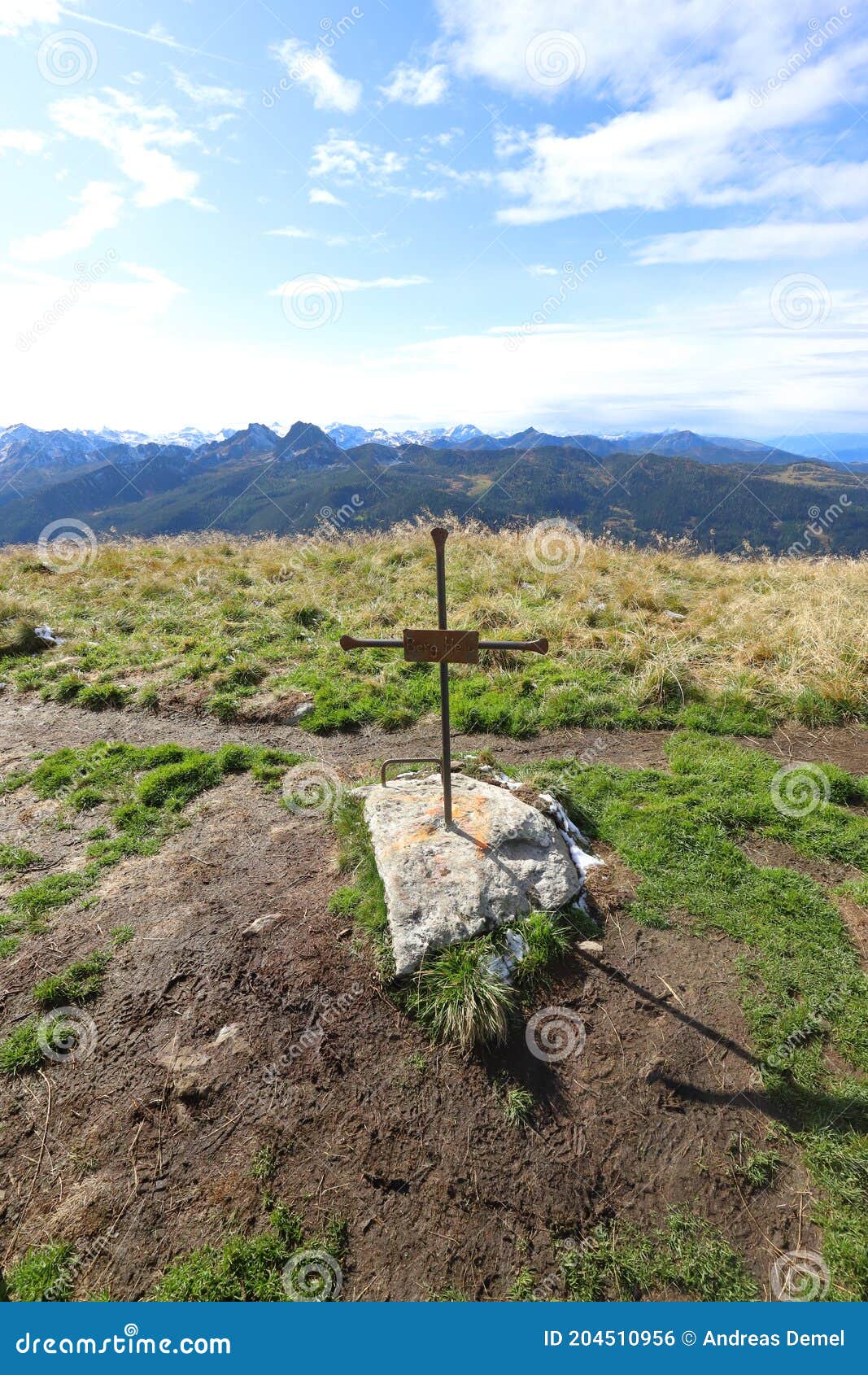 a cross with the inscript `berg heil` stands directly aside the mountain trail above the reiteralm