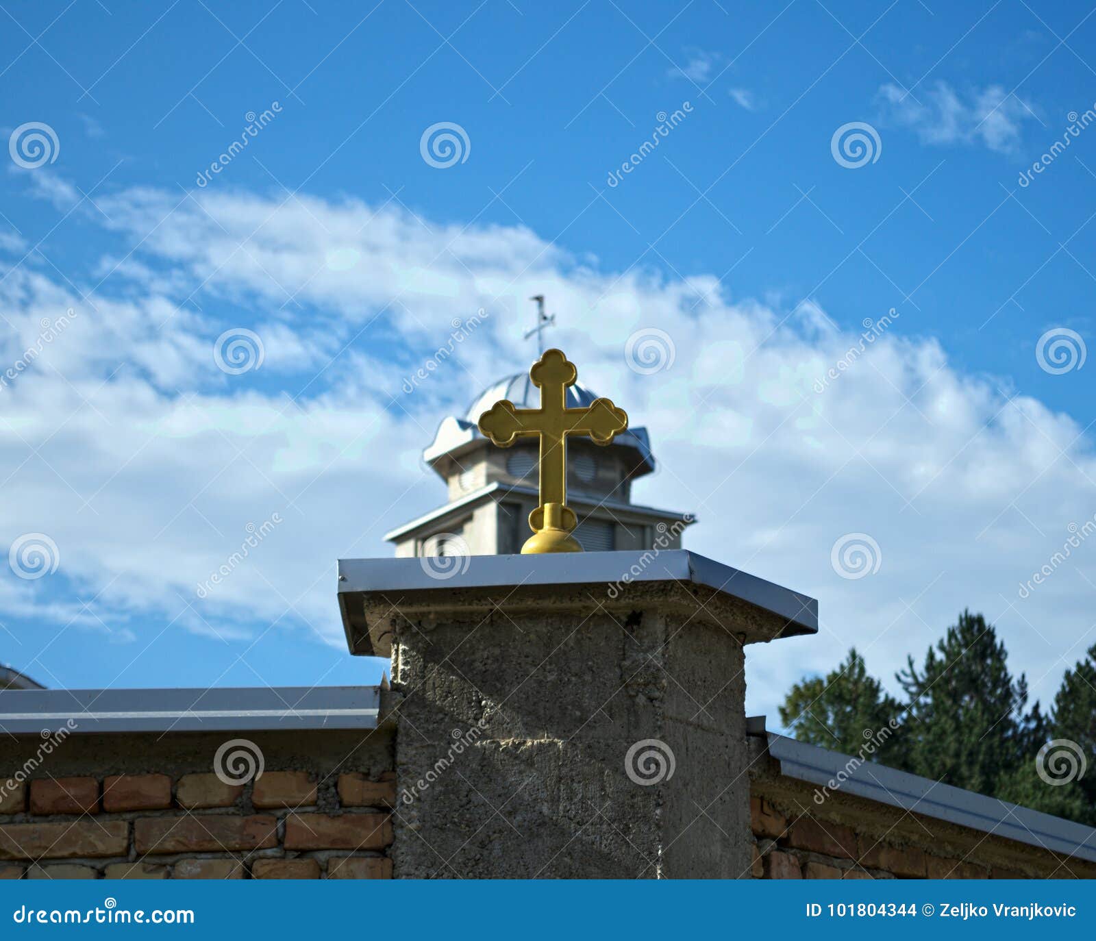 Cross on Monastery Fence and Church Dome in Background Stock Photo