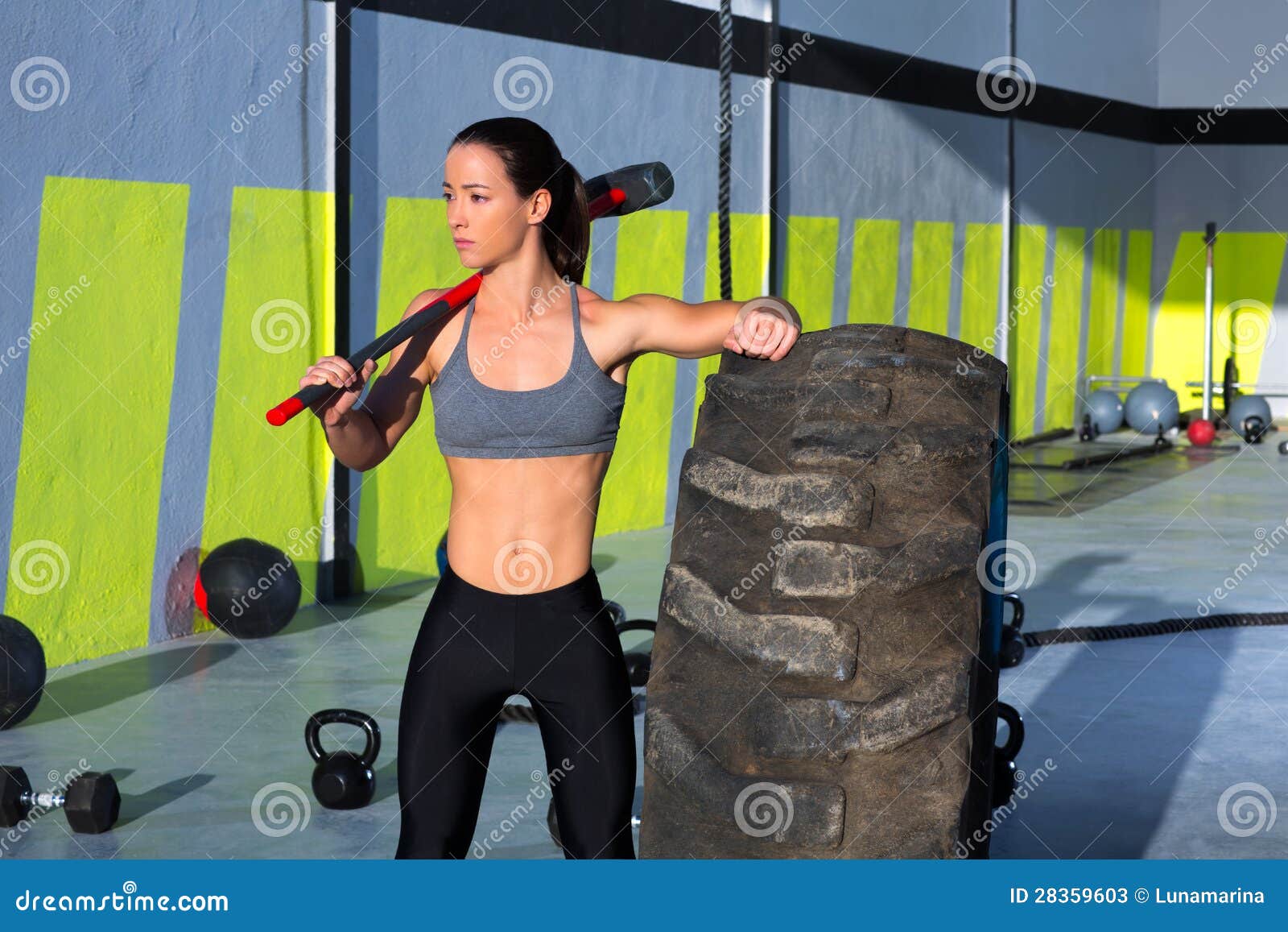 crossfit sledge hammer woman at gym relaxed