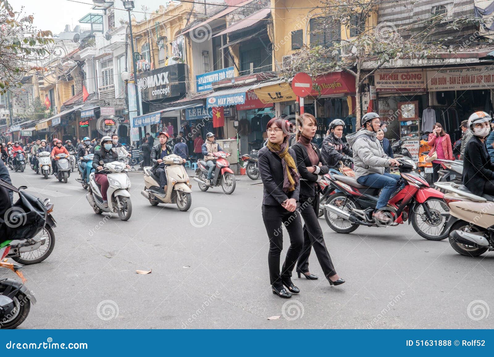 People Crossing Street In The Busy Streets Of Hanoi, Vietnam Stock