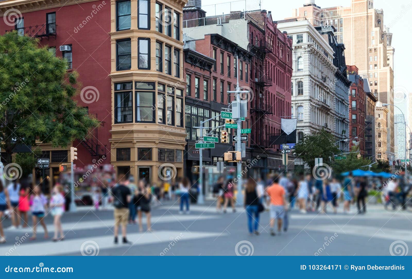 Crowd of anonymous people walking through Union Square Park in Manhattan, New York City NYC