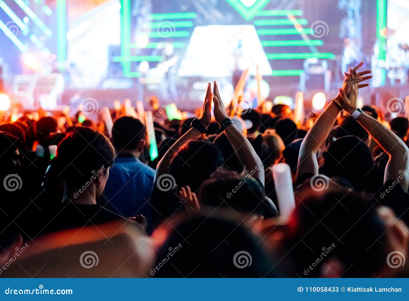 crowd clap or hands up at concert stage lights