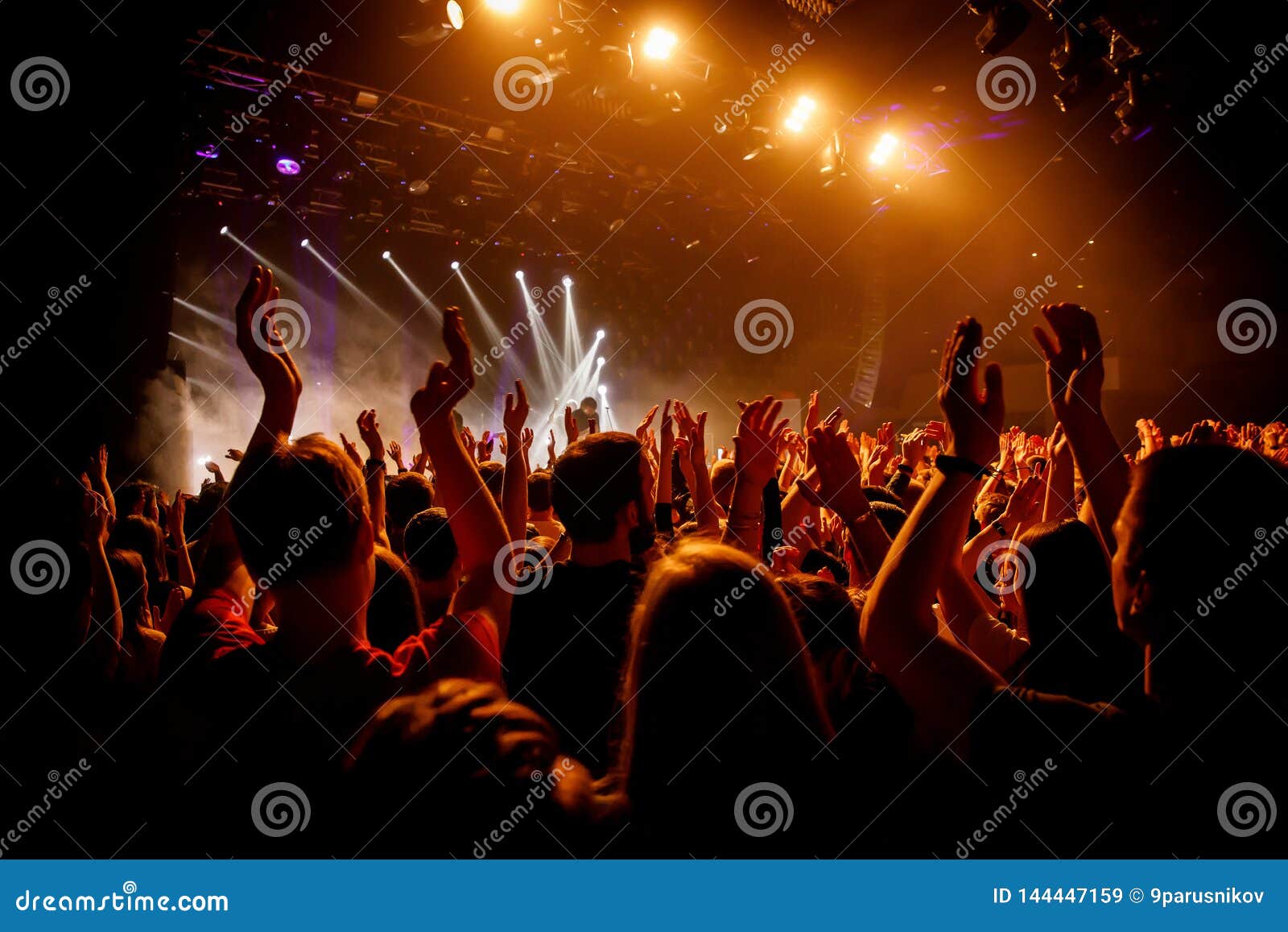 Crowd on Music Show, Happy People with Raised Hands. Orange Stage Light ...