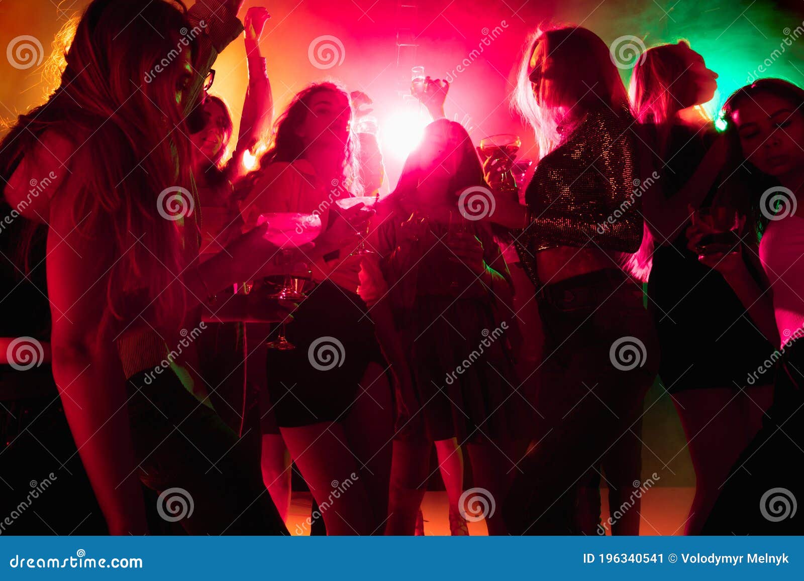 A Crowd of People in Silhouette Raises Their Hands on Dancefloor on ...