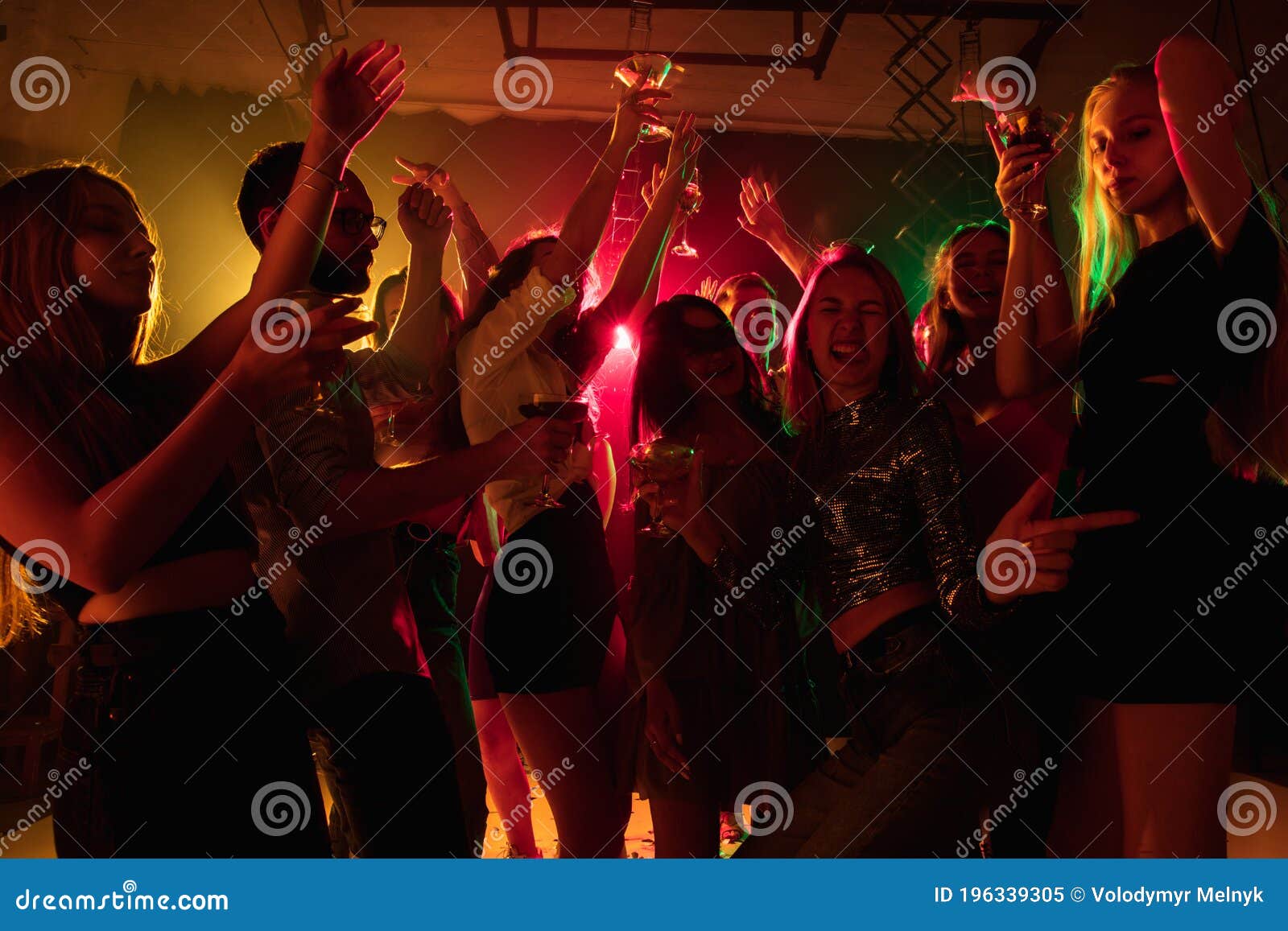 A Crowd of People in Silhouette Raises Their Hands on Dancefloor on ...