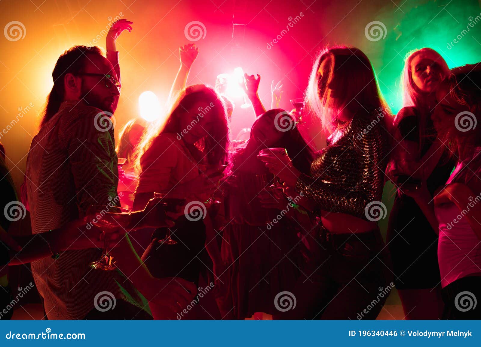 A Crowd of People in Silhouette Raises Their Hands on Dancefloor on ...