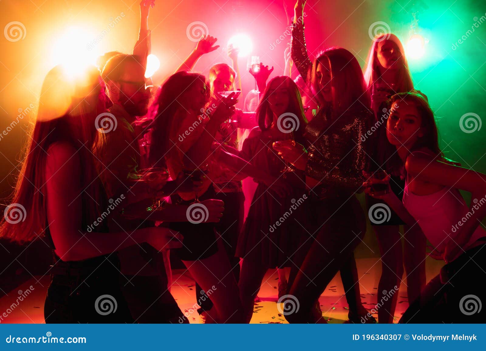 A Crowd Of People In Silhouette Raises Their Hands On Dancefloor On ...