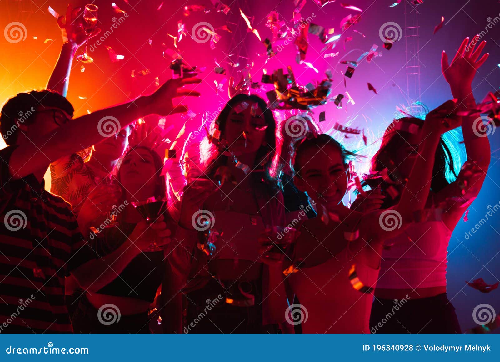 A Crowd of People in Silhouette Raises Their Hands on Dancefloor on ...