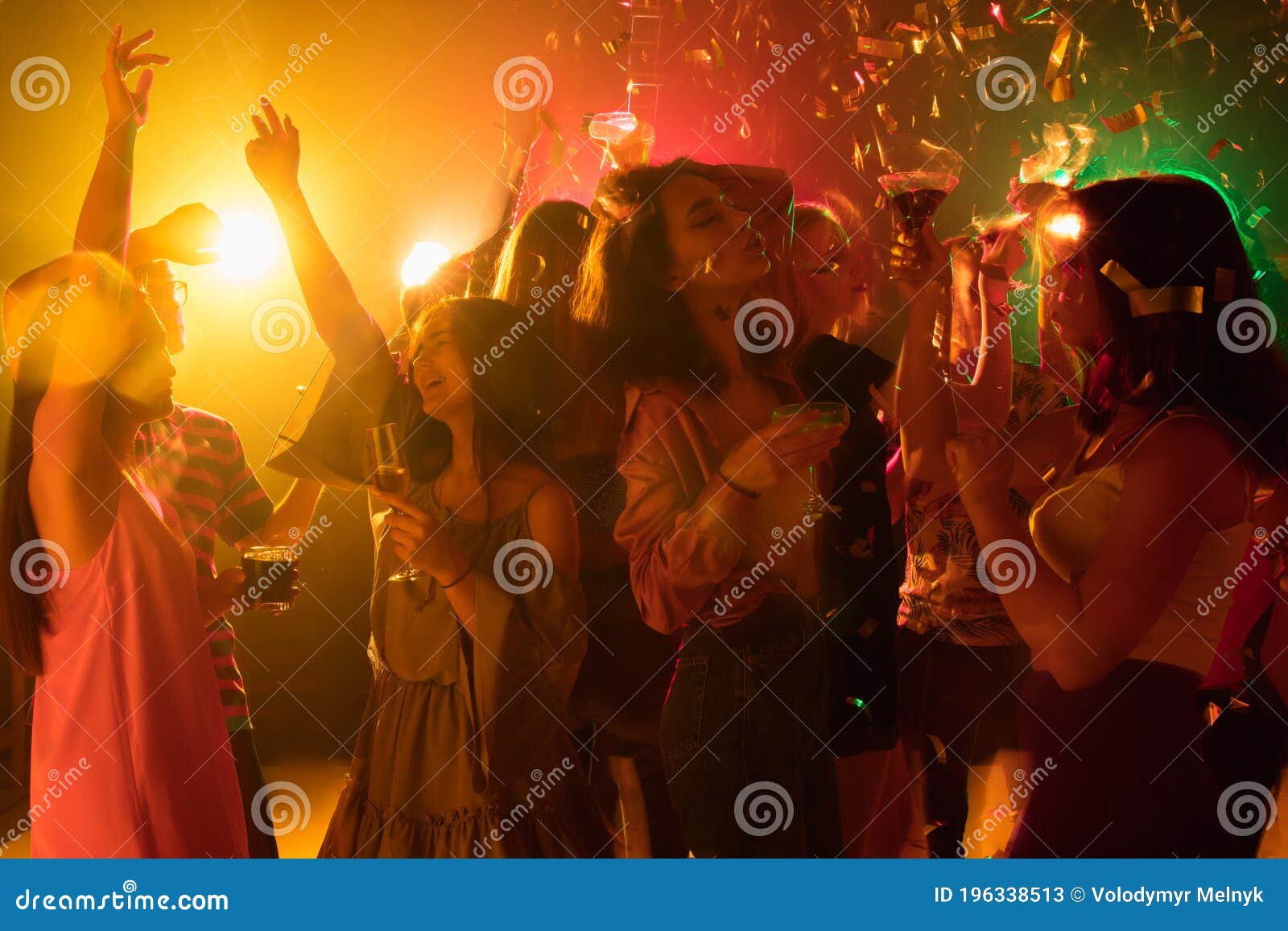 A Crowd of People in Silhouette Raises Their Hands on Dancefloor on ...