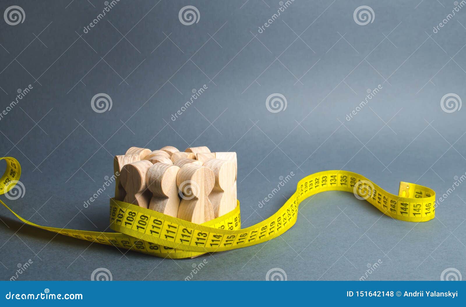 a crowd of wooden figures gripped by measuring tape. social sciences. promotion of ideas for weight loss, lifestyle. information