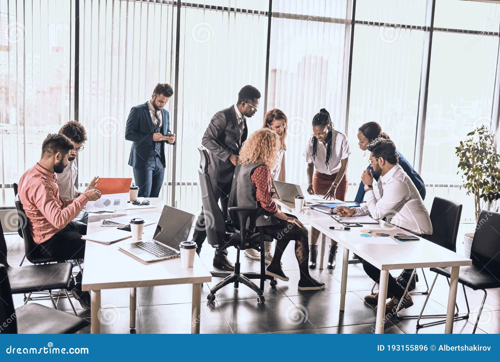 crowded office room with hardworking people