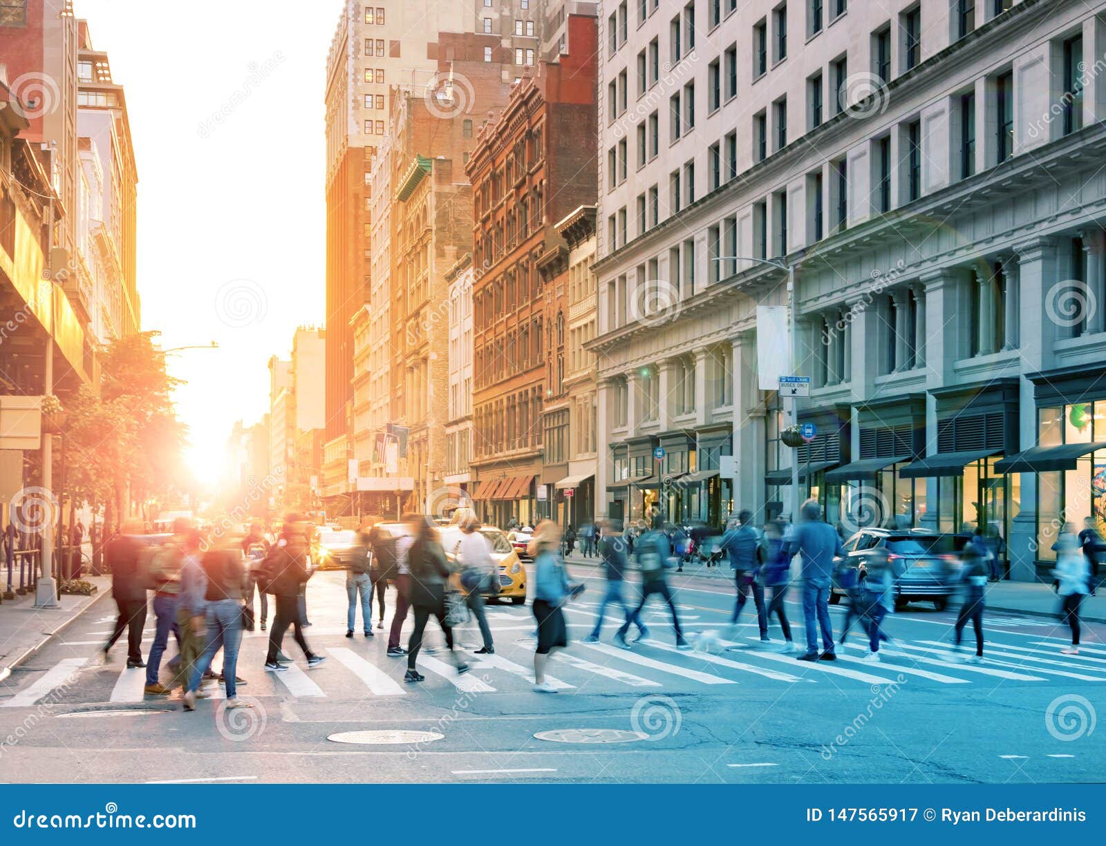 crowds of people walking across the busy intersection in midtown manhattan, new york city
