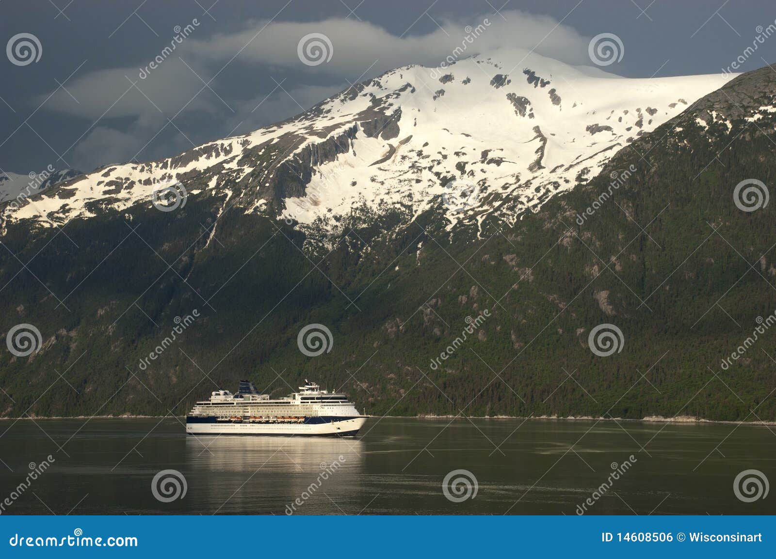 cruise ship crusing fjord in alaska inside passage