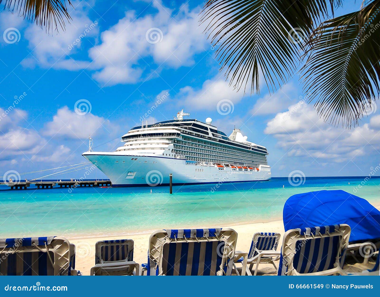 cruise ship docked at caribbean beach.