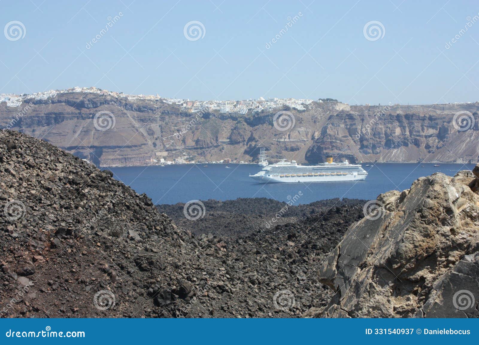 cruise ship watched from nea kameni, the volcanic island in santorini