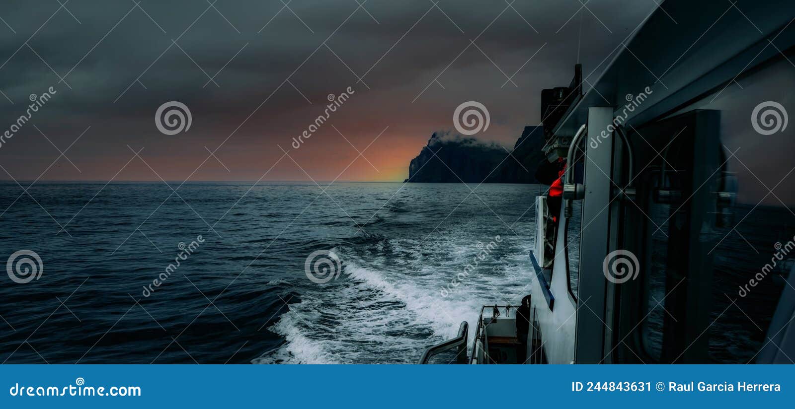 cruising the breathtaking faroe islands on a motor boat at sunset. vestmanna, streymoy, faroe islands.