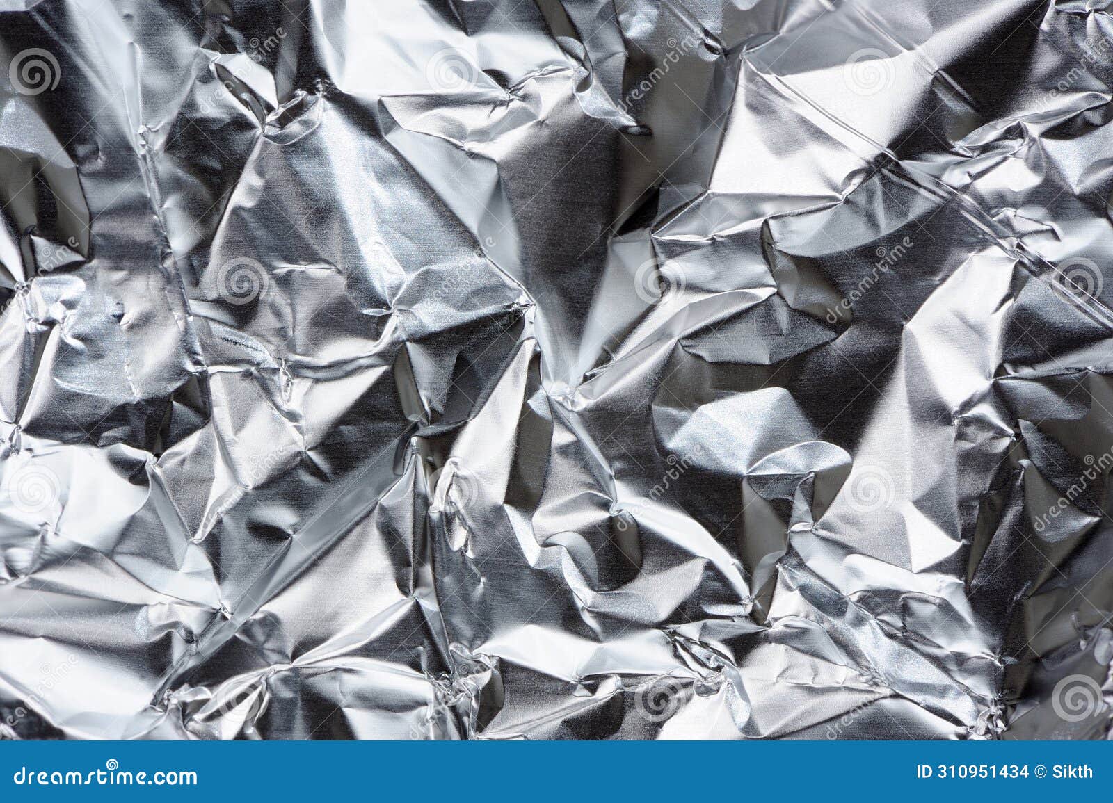 crumpled aluminum foil with folds and creases as background