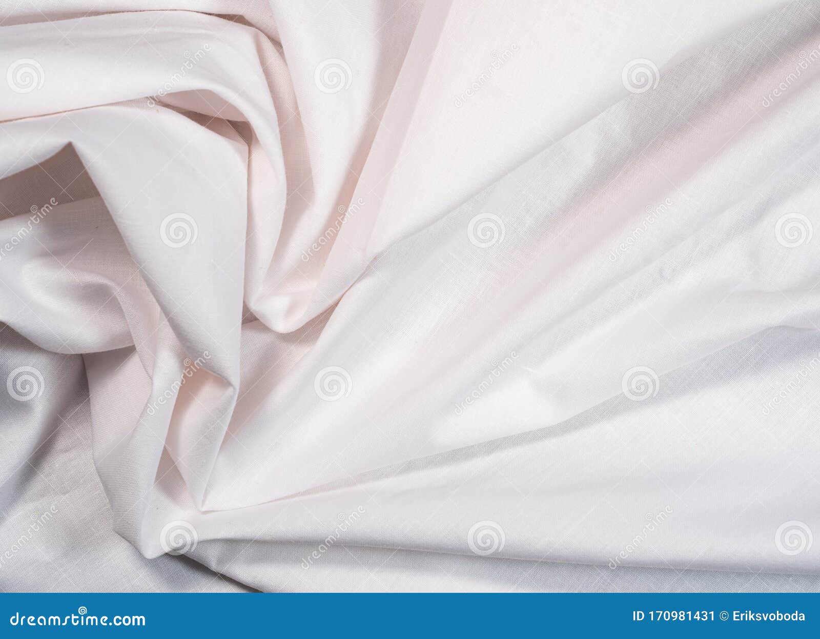 Crumpled White Sheet, Close Up View. White Textile, An Abstract Background. Texture Of Crumpled