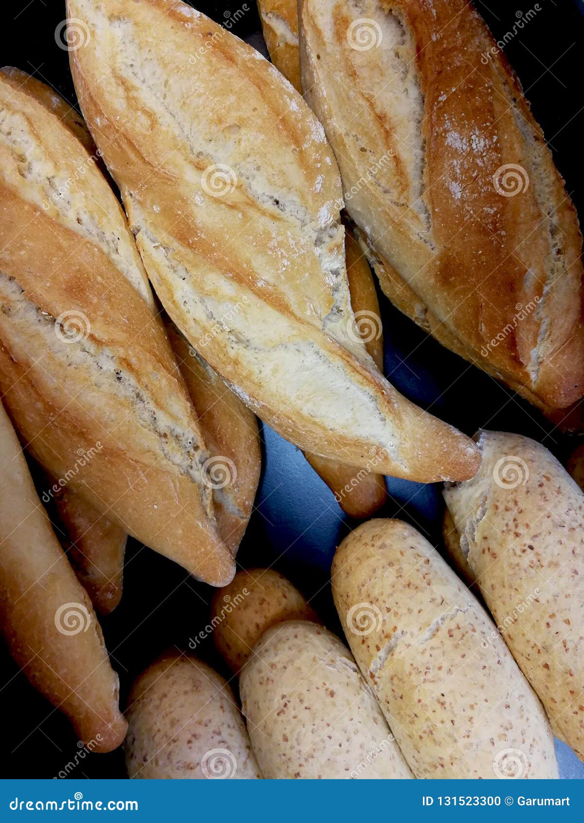 Bread rolls in the bakery stock photo. Image of cereal 131523300