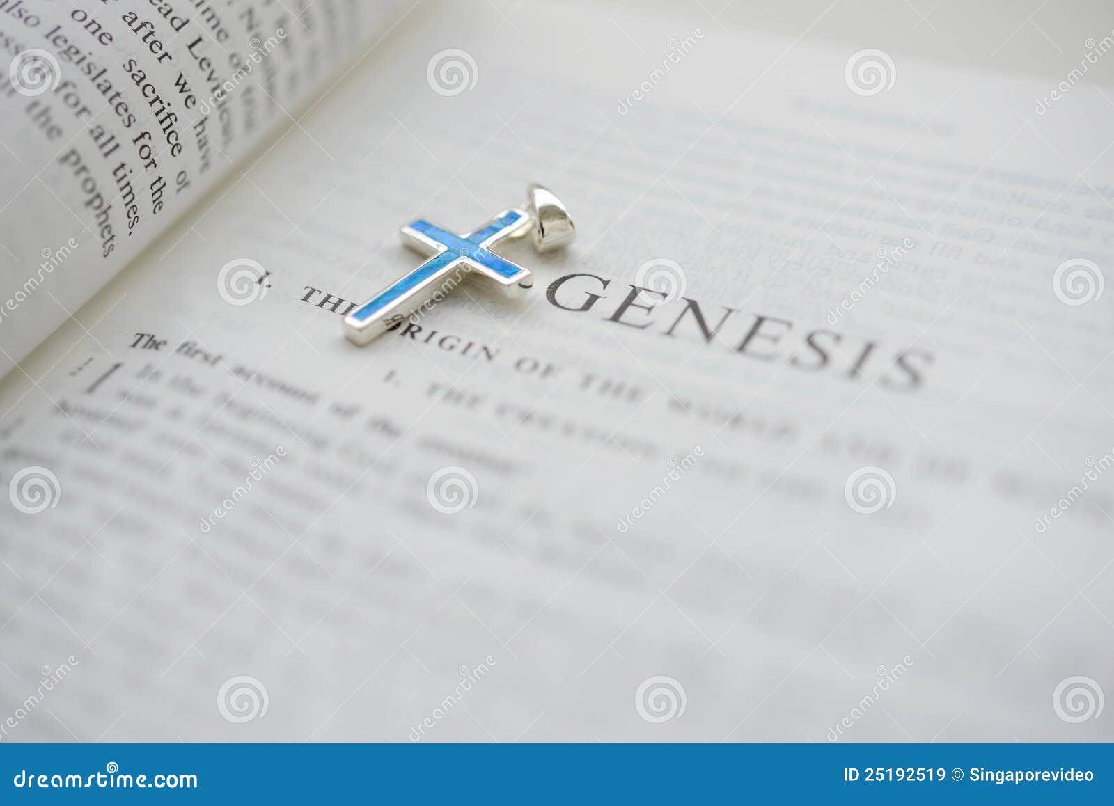 cruxific close to the word genesis on the bible