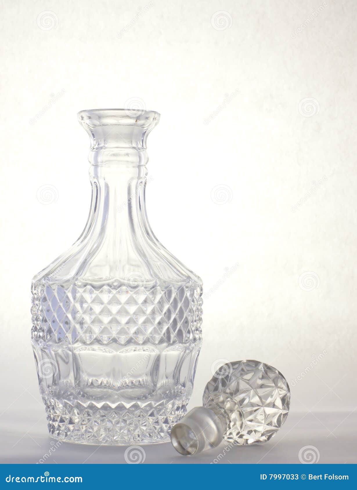 A Crystal Decanter With A Lid And Two Glasses With Cognac Stand On A Brown Abstract Background