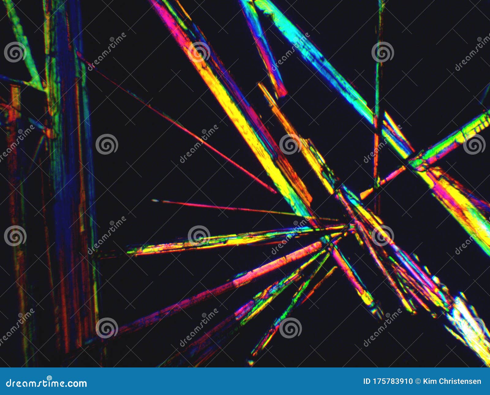 crystal layer on microscope object glass, seen in polarized light. this causes random unforeseeable color effects