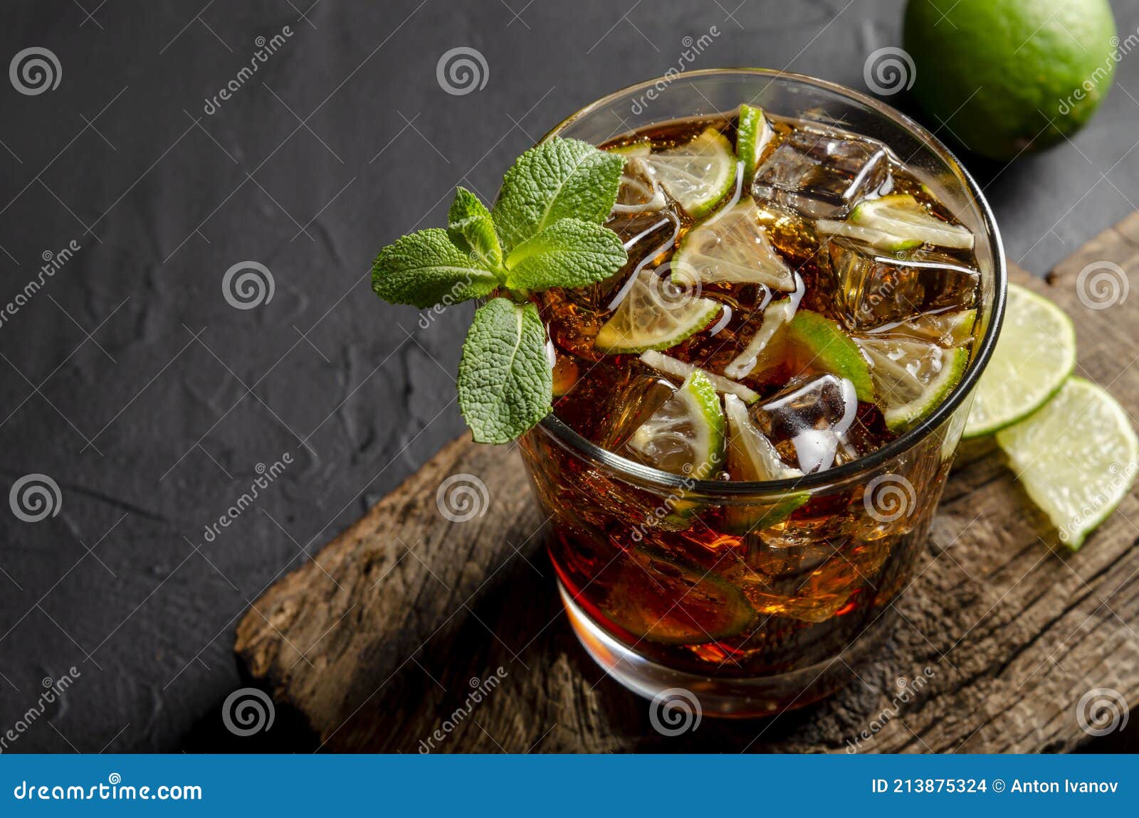 Cuba Libre, Rum and Cola Cocktail in Glass with a Lime and Mint on