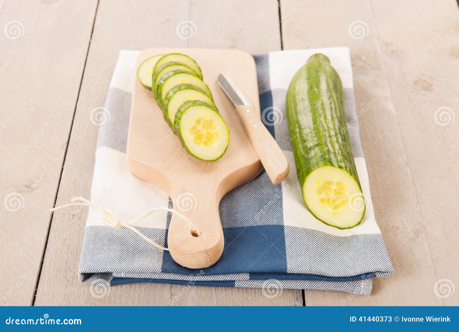 Cucumber slices. Cucumber cut on wooden cutting board with knife