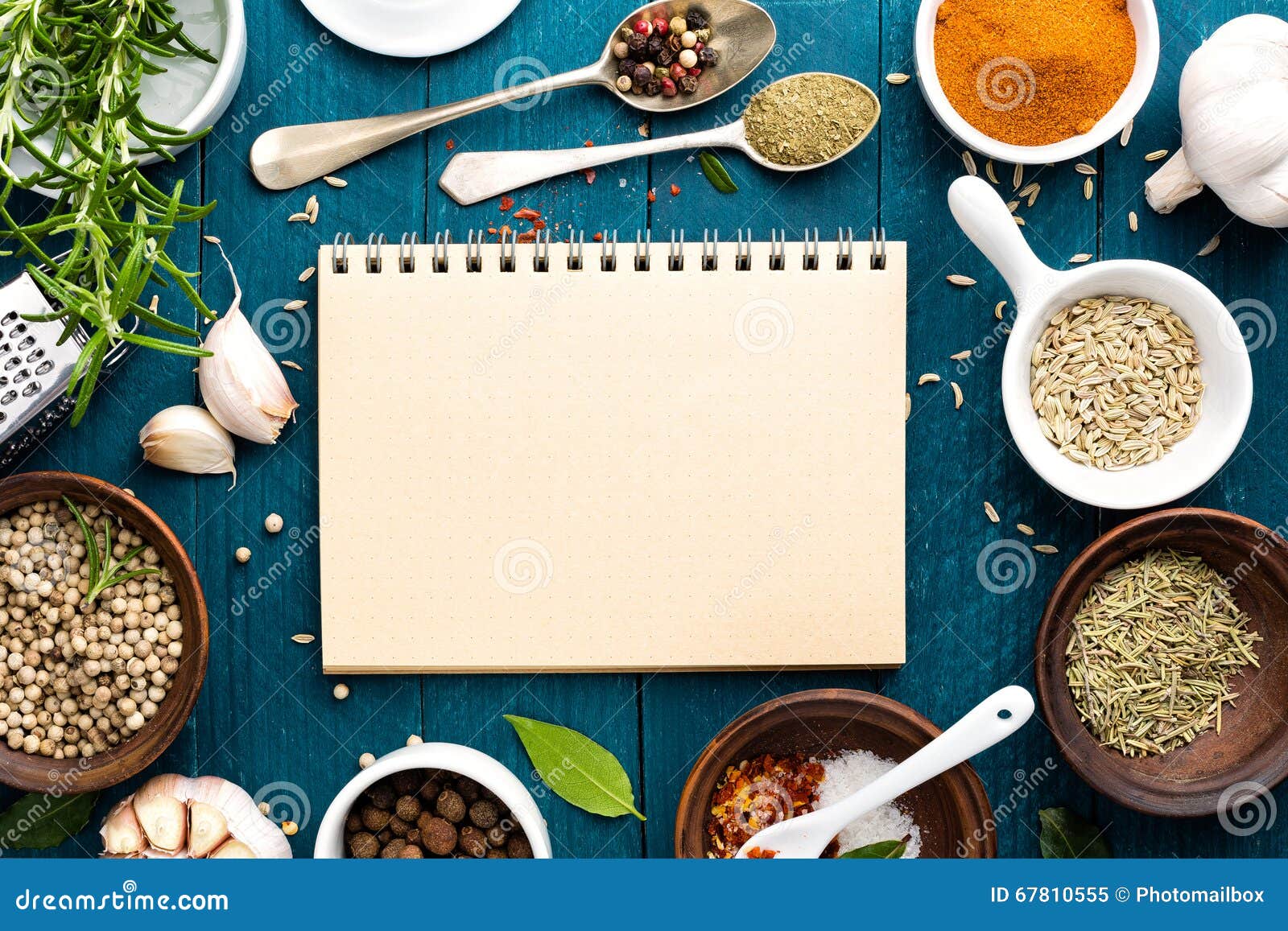 culinary background and recipe book with spices on wooden table