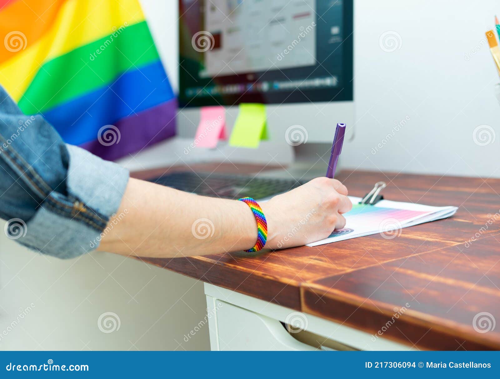 cultura lgbtqia. woman working in office with lgbt accessories