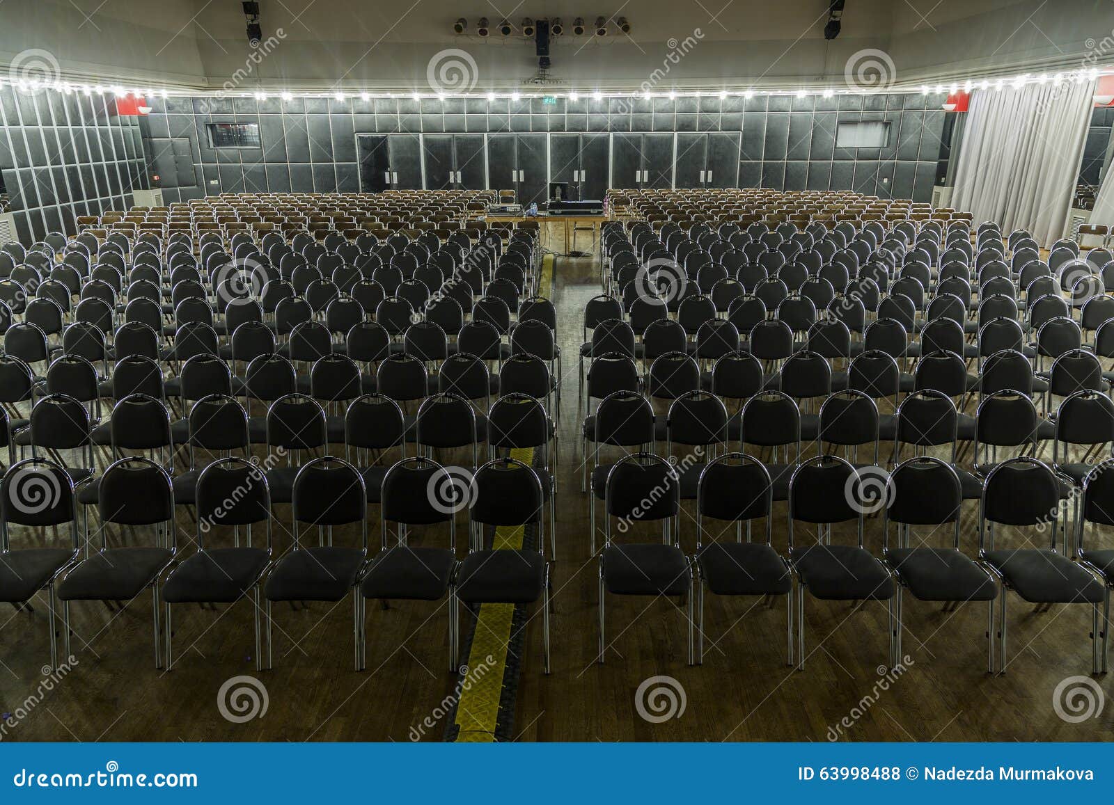 Cultural Hall with Chairs in Rows, Colorfully Lit, Selective Focus