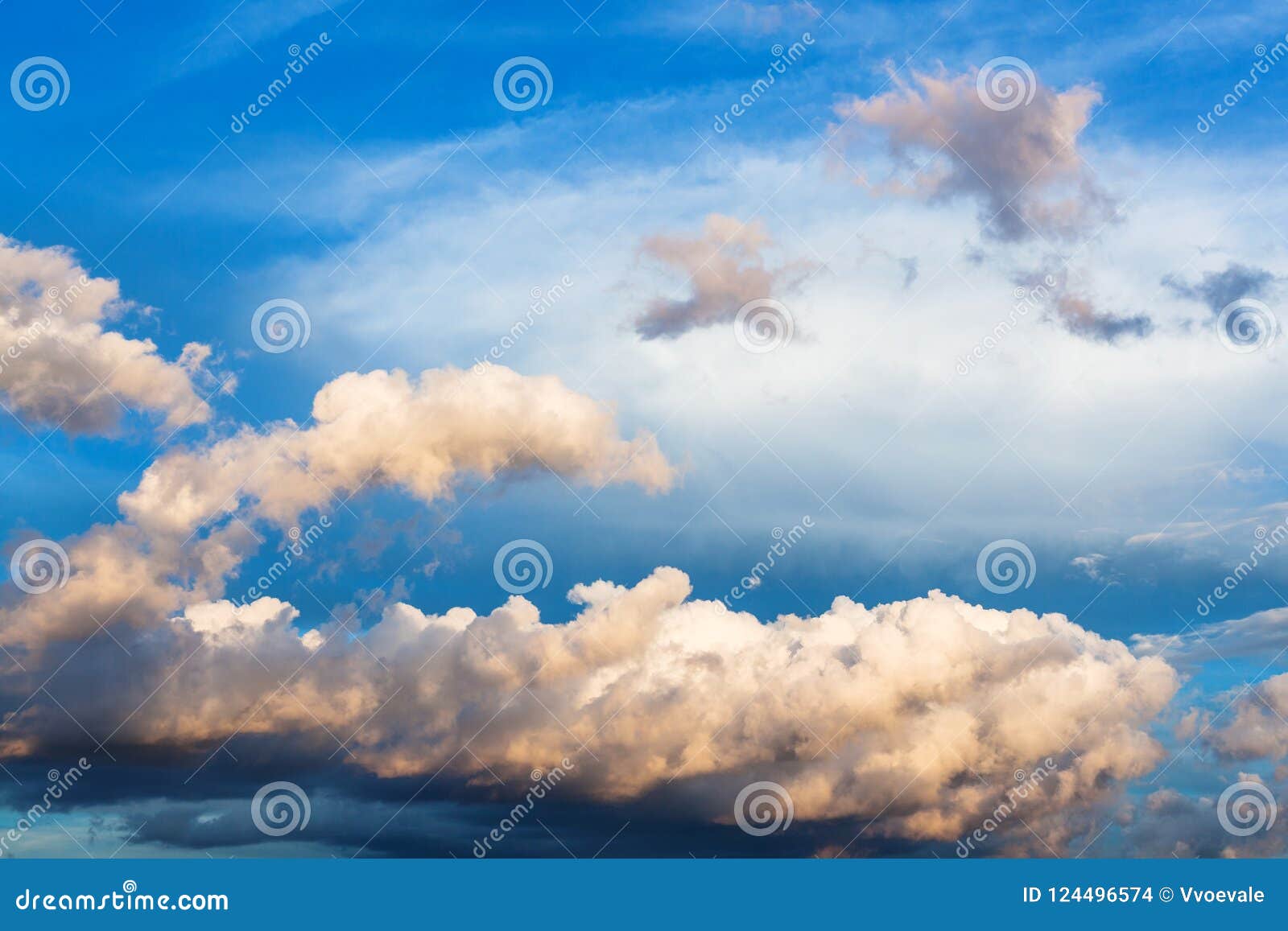 cumuli clouds in dark blue sky in summer evening