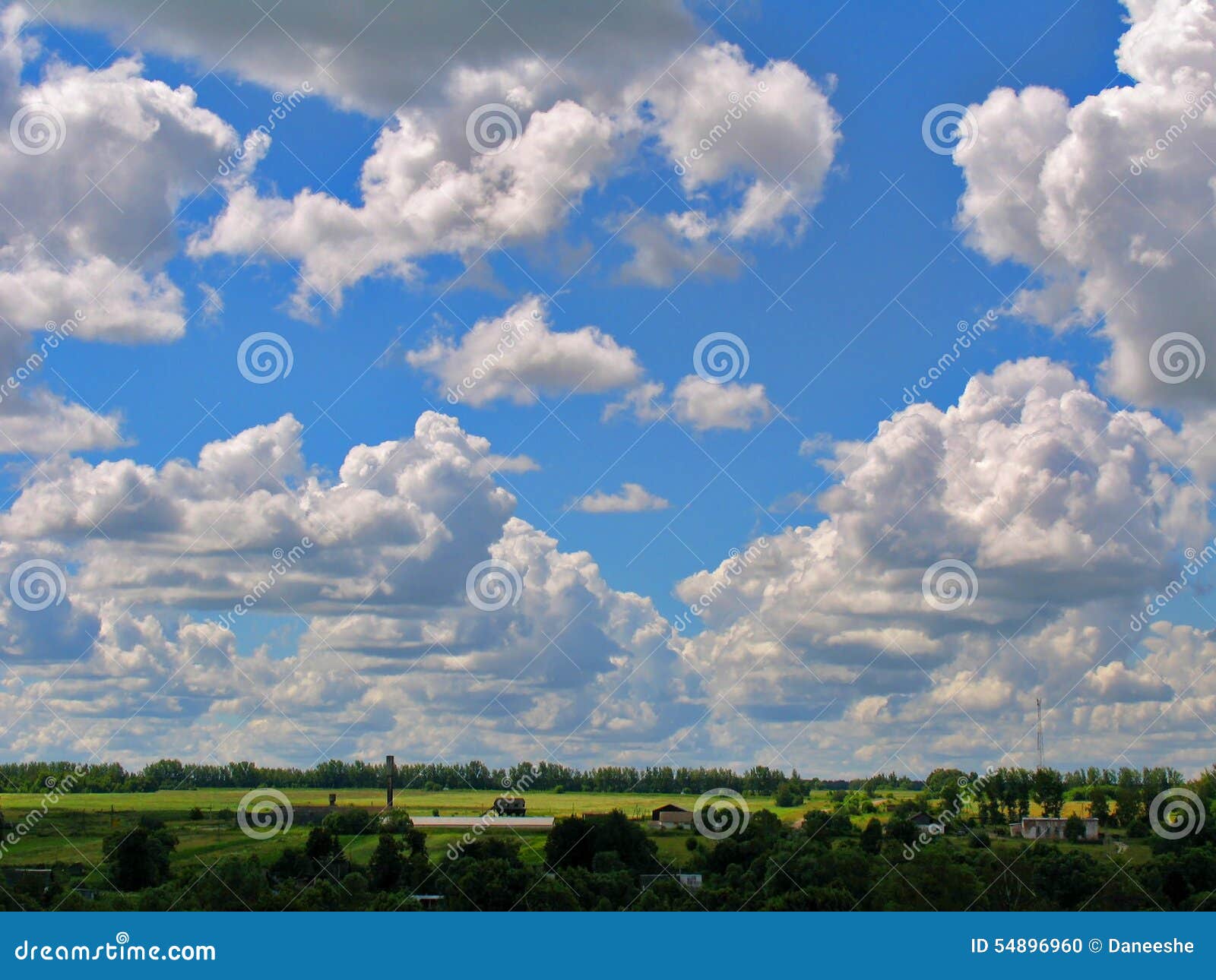 Cumulus clouds cascade on a bright blue sky. Cumulus clouds cascade in the form of a tick on a bright blue sky