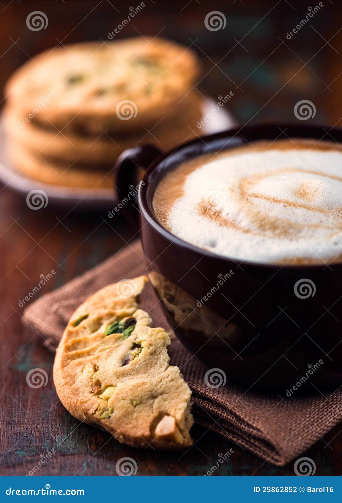 cup of cafe au lait and pistachio cookie