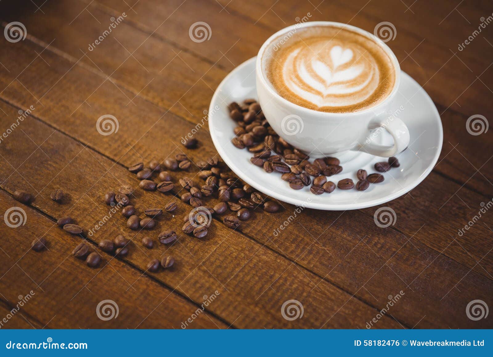 cup of cappuccino with coffee art and coffee beans