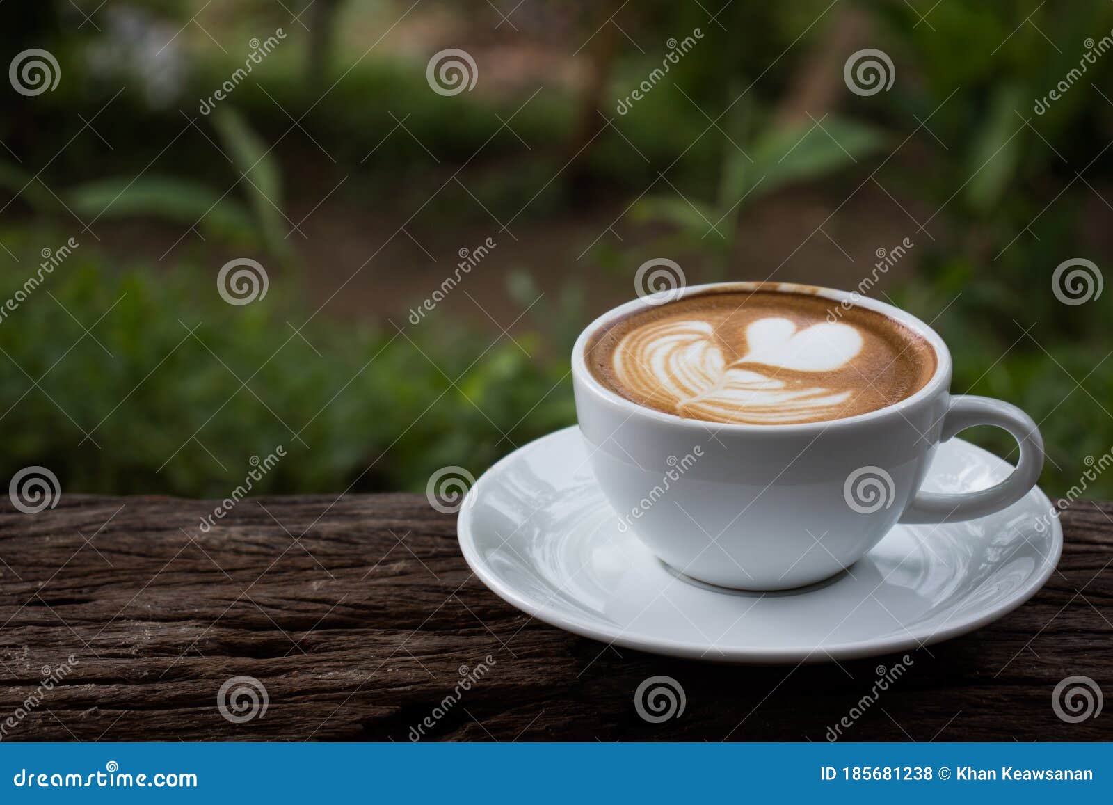 a cup of cappuchino coffee  on wooden table