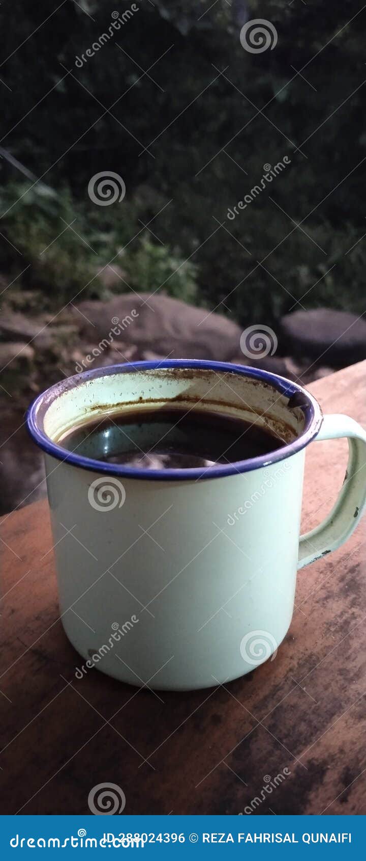 A Cup of Coffee at the Campground Against the River Stock Photo Image